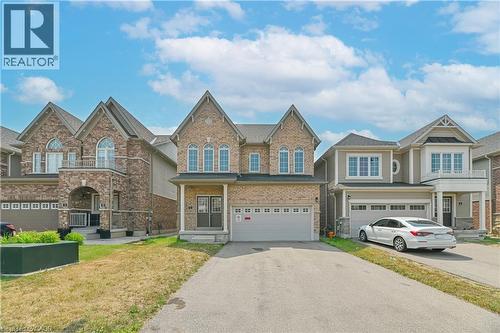 Elegant two-story colonial featuring a stone and brick exterior with peaked gable rooflines and arched upper-level windows - 24 Weatherall Avenue, Cambridge, ON - Outdoor With Facade
