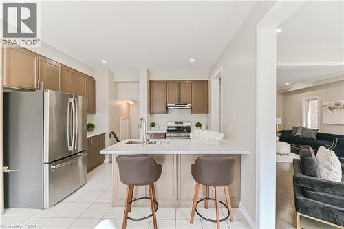 Kitchen featuring stainless steel appliances, upper and lower cabinetry, an undermount sink, and a countertop island with seating - 24 Weatherall Avenue, Cambridge, ON - Indoor Photo Showing Kitchen With Upgraded Kitchen