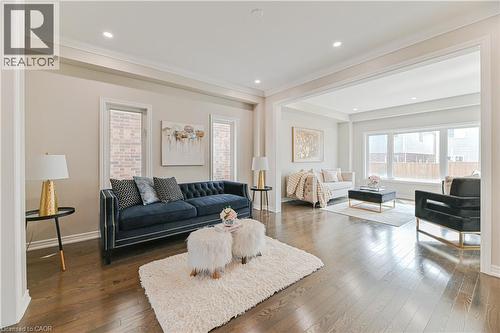 Spacious living area featuring dark wood-finish flooring, recessed lighting, and crown molding - 24 Weatherall Avenue, Cambridge, ON - Indoor Photo Showing Living Room