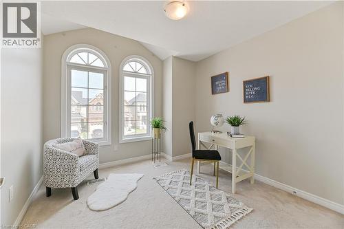 Two arched windows, sloped ceiling, light-toned wall paint, and recessed lighting - 24 Weatherall Avenue, Cambridge, ON - Indoor