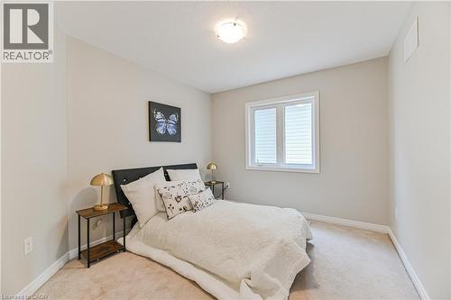 Neutral-toned walls, carpeted flooring, and a flush mount ceiling light - 24 Weatherall Avenue, Cambridge, ON - Indoor Photo Showing Bedroom