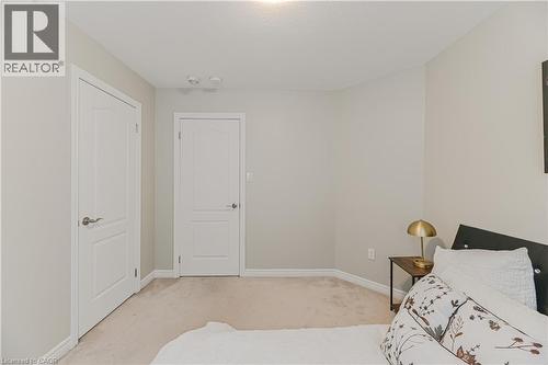 Neutral wall paint, light-colored carpeting, and white trim - 24 Weatherall Avenue, Cambridge, ON - Indoor Photo Showing Bedroom