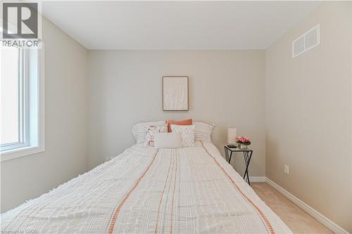 Carpeted flooring, neutral wall tones, and a window with white trim - 24 Weatherall Avenue, Cambridge, ON - Indoor Photo Showing Bedroom