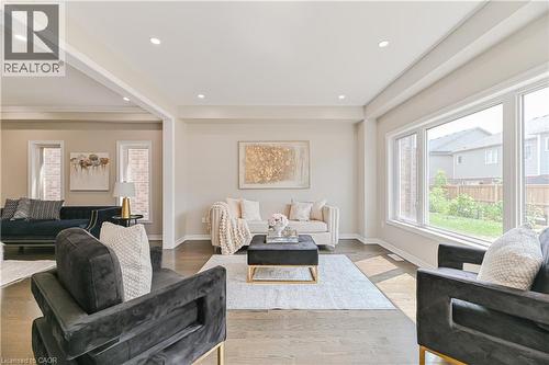 Recessed lighting, wood-finish flooring, broad windows, and an open layout define this living space - 24 Weatherall Avenue, Cambridge, ON - Indoor Photo Showing Living Room