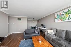 Wood-finish flooring, crown molding, neutral wall paint, and recessed lighting - 