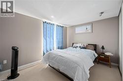 Carpeted flooring, neutral wall paint, and a built-in closet with sliding doors - 