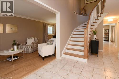 Curved staircase with wood-finish treads and white risers - 470 Amanda Crescent, Burlington, ON - Indoor Photo Showing Other Room