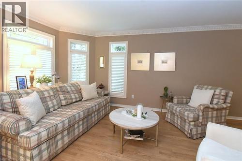 Light wood-finish flooring, crown molding, and window shutters - 470 Amanda Crescent, Burlington, ON - Indoor Photo Showing Living Room