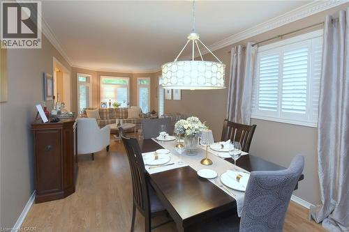 Recessed lighting, wood-finish flooring, bay window, white window shutters, and crown molding - 470 Amanda Crescent, Burlington, ON - Indoor Photo Showing Dining Room