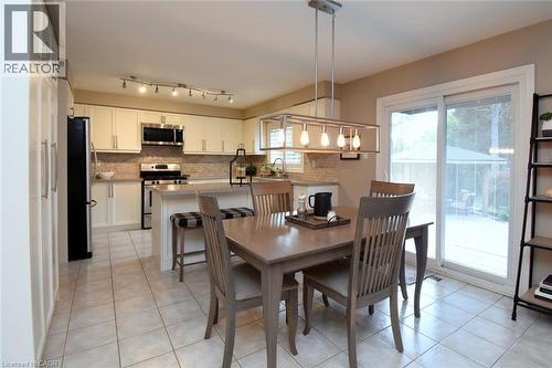 Kitchen with light-toned cabinetry, stainless steel appliances, and a tiled backsplash - 470 Amanda Crescent, Burlington, ON - Indoor Photo Showing Other Room