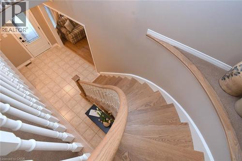 Curved staircase with wood-finish treads and white balusters - 470 Amanda Crescent, Burlington, ON - Indoor Photo Showing Other Room