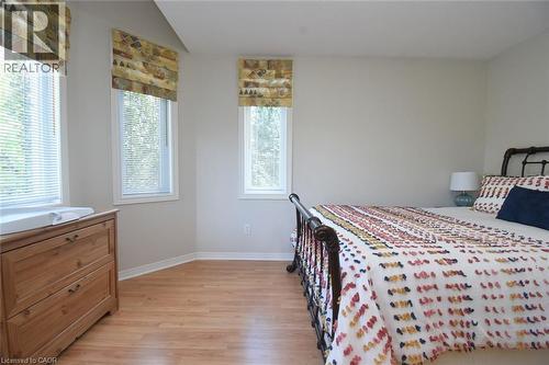 Wood-finish flooring, multiple windows with blinds, and neutral wall paint - 470 Amanda Crescent, Burlington, ON - Indoor Photo Showing Bedroom