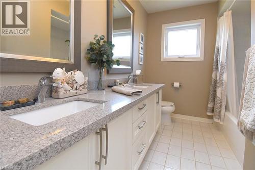 Dual vanity with undermount sinks, light-toned countertop, and white cabinetry - 470 Amanda Crescent, Burlington, ON - Indoor Photo Showing Bathroom