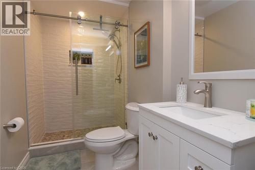 Walk-in shower with a glass enclosure and textured tile surround - 470 Amanda Crescent, Burlington, ON - Indoor Photo Showing Bathroom