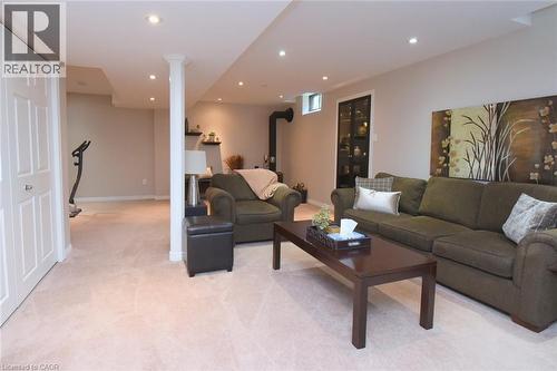 Recessed lighting, plush carpeting, built-in shelving, white paneled doors, and a decorative column - 470 Amanda Crescent, Burlington, ON - Indoor Photo Showing Living Room