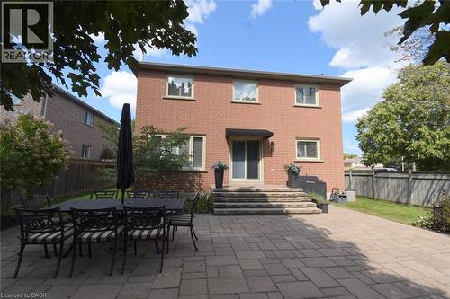 Brick exterior with multiple windows, sliding glass door, and a paver patio - 470 Amanda Crescent, Burlington, ON - Outdoor With Deck Patio Veranda