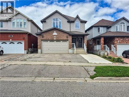 Brick and siding exterior with a dual-door entry and an arched transom window - 128 Udvari Crescent Unit# A, Kitchener, ON - Outdoor With Facade