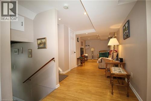 Laminate  flooring throughout, recessed ceiling lighting, and a white paneled door - 14 Berkley Crescent, Simcoe, ON - Indoor Photo Showing Other Room