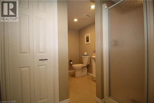 Dedicated powder room featuring warm neutral finishes, recessed ceiling lighting, and ceramic tile flooring - 14 Berkley Crescent, Simcoe, ON - Indoor Photo Showing Bathroom