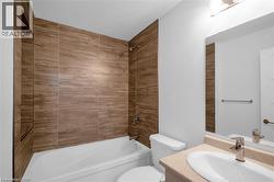 Bathtub with wood-finish tile surround and built-in shower niche - 