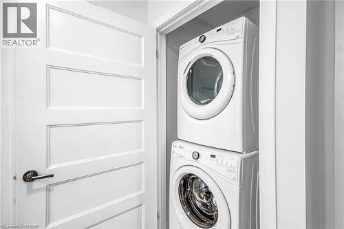 Stackable laundry appliances within a dedicated closet - 961 Battery Park, London, ON - Indoor Photo Showing Laundry Room