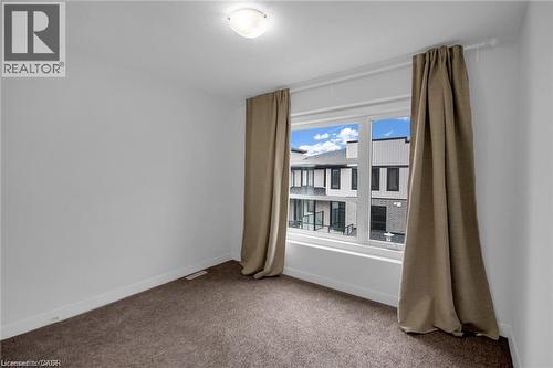 Bright room with neutral wall paint, brown carpet, and a large window - 961 Battery Park, London, ON - Indoor Photo Showing Other Room