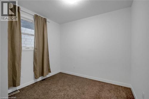 White painted walls with brown carpeting and a single window - 961 Battery Park, London, ON - Indoor Photo Showing Other Room