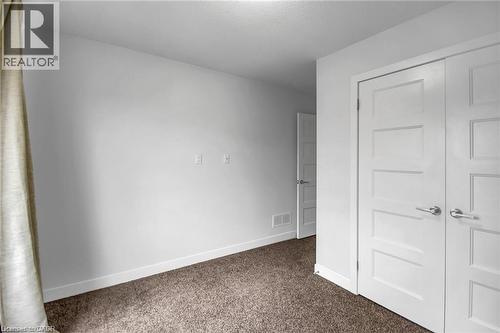Wall-to-wall carpeting, modern interior doors, and white trim - 961 Battery Park, London, ON - Indoor Photo Showing Other Room