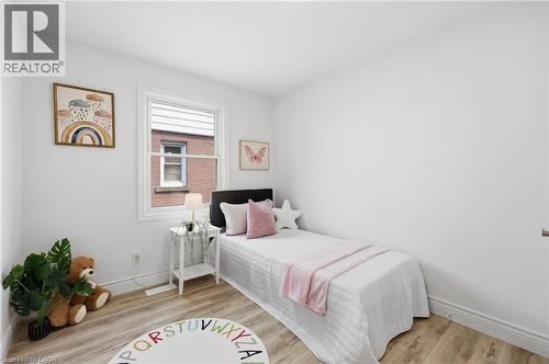 Light wood-finish flooring, white walls, and a single window with white trim - 156 East 36Th Street, Hamilton, ON - Indoor Photo Showing Bedroom
