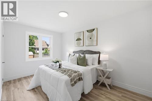 Recessed lighting, wood-finish flooring, white trim, and a window with a white frame - 156 East 36Th Street, Hamilton, ON - Indoor Photo Showing Bedroom