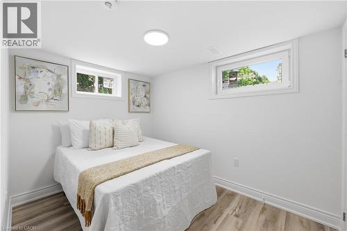 Recessed windows, wood-finish flooring, white walls, and a ceiling-mounted light fixture - 156 East 36Th Street, Hamilton, ON - Indoor Photo Showing Bedroom