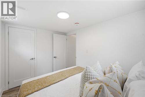 Recessed ceiling light fixture, crown molding, and wood-finish flooring - 156 East 36Th Street, Hamilton, ON - Indoor Photo Showing Bedroom