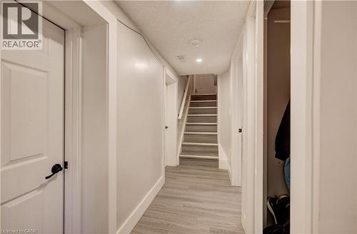 Hallway featuring wood-finish flooring, recessed lighting, and a stairway with carpeted treads - 361 Prospect Avenue, Kitchener, ON - Indoor Photo Showing Other Room