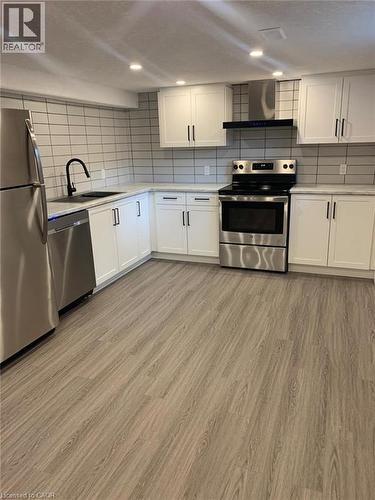 Modern kitchen featuring stainless steel appliances, white shaker cabinetry, and wood-finish flooring - 361 Prospect Avenue, Kitchener, ON - Indoor Photo Showing Kitchen