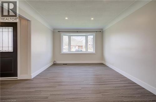 Spacious interior featuring a prominent bay window, recessed lighting, crown molding, and wood-finish flooring - 361 Prospect Avenue, Kitchener, ON - Indoor Photo Showing Other Room