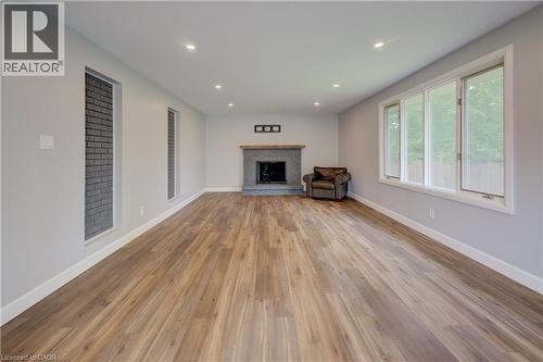 Expansive interior space featuring wood-finish flooring, recessed lighting, and a stone-clad fireplace with a wood mantel - 244 Royal Street, Waterloo, ON - Indoor Photo Showing Living Room