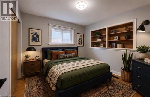 Recessed built-in shelving, wood-finish flooring, white trim details, and a flush-mount ceiling light - 244 Royal Street, Waterloo, ON - Indoor Photo Showing Bedroom
