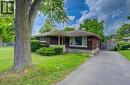 Brick exterior with white trim, covered front porch, and mature trees - 244 Royal Street, Waterloo, ON  - Outdoor 