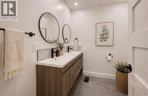 Dual vanity with wood-finish cabinetry, white countertop, and matte black fixtures - 244 Royal Street, Waterloo, ON - Indoor Photo Showing Bathroom