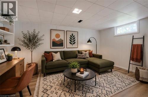 Wood-finish flooring, white panel walls, and a drop ceiling with recessed lighting - 244 Royal Street, Waterloo, ON - Indoor Photo Showing Living Room