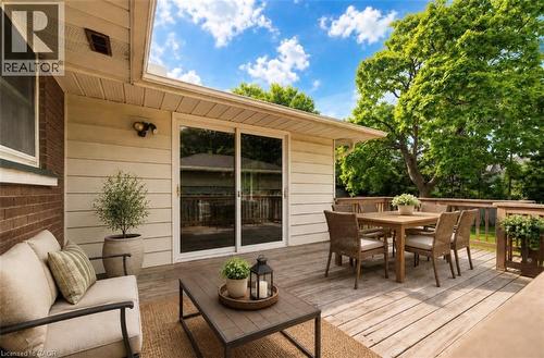 Expansive wood deck with a full-height wood railing, siding exterior, and sliding glass doors - 244 Royal Street, Waterloo, ON - Outdoor With Deck Patio Veranda With Exterior