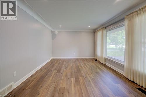 Wood-finish flooring with white trim, recessed lighting, and a large picture window - 244 Royal Street, Waterloo, ON - Indoor Photo Showing Other Room