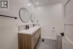Dual vanity with wood-finish cabinetry, white countertop, and black fixtures - 
