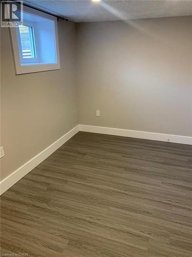 Interior space featuring wood-finish flooring, light tan walls, and white trim - 361 Prospect Avenue, Kitchener, ON - Indoor Photo Showing Other Room