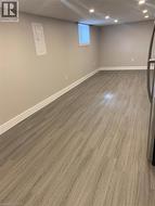 Recessed lighting illuminates wood-finish flooring - 