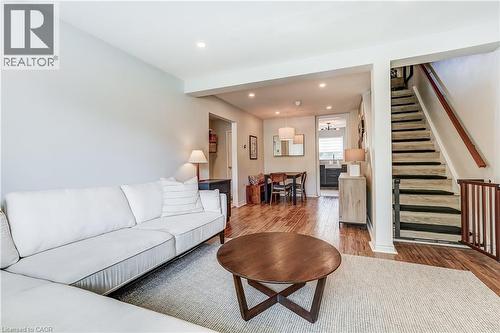 Hardwood-style flooring throughout, recessed lighting, open concept layout, and a staircase with a wood handrail - 2488 Brookhurst Road, Mississauga, ON - Indoor Photo Showing Living Room