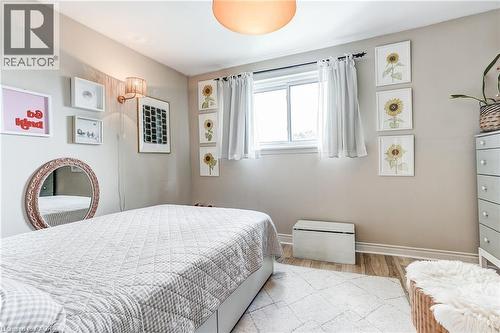 Recessed window with white trim, wood-finish flooring, and a wall-mounted sconce - 2488 Brookhurst Road, Mississauga, ON - Indoor Photo Showing Bedroom