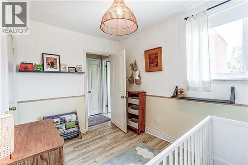 Wood-finish flooring, white walls, and a window with a built-in shelf - 2488 Brookhurst Road, Mississauga, ON - Indoor Photo Showing Other Room