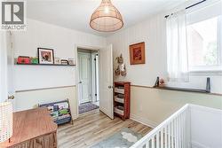 Wood-finish flooring, white walls, and a window with a built-in shelf - 