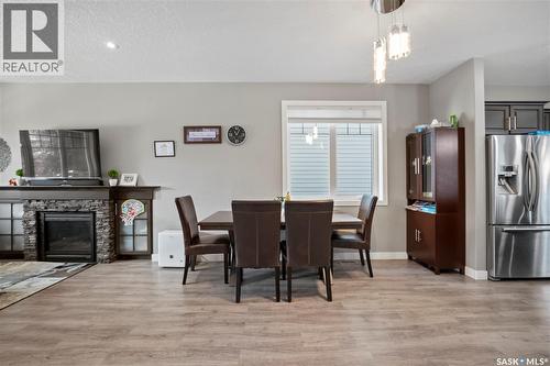 8726 Archer Lane, Regina, SK - Indoor Photo Showing Dining Room With Fireplace